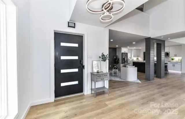 a view of a hallway with wooden floor and a large window