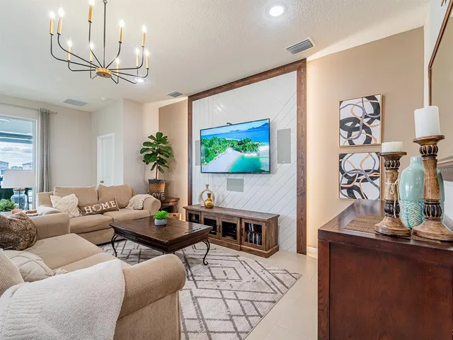 an aerial view of a swimming pool with a yard and lake view