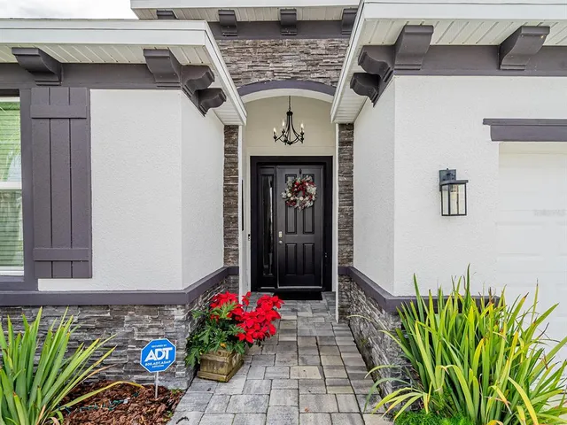 a living room with furniture a flat screen tv and a window