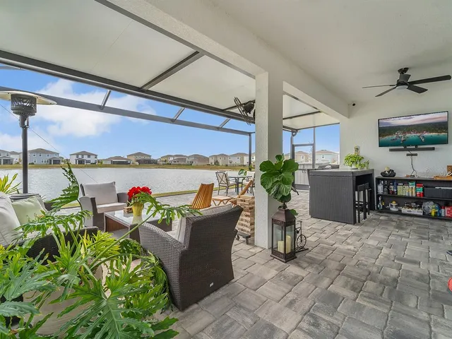 a living room with furniture a large window and a flat screen tv