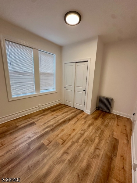 128 King Street, Unit 2 Nutley, NJ 07110 - Photo 7 of 8 a view of empty room with window and wooden floor