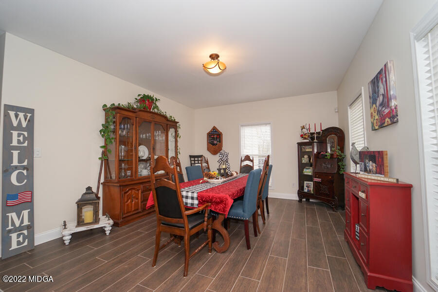 5281 Purple Road Byron, GA 31008 - Photo 18 of 42 a view of a dining room with furniture and wooden floor