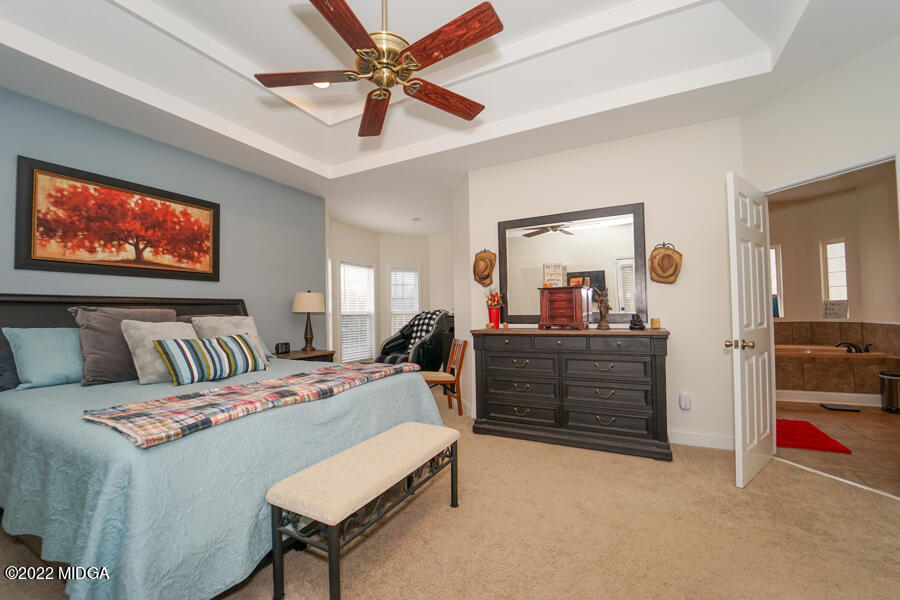 5281 Purple Road Byron, GA 31008 - Photo 21 of 42 a bed room with a bed and a chandelier