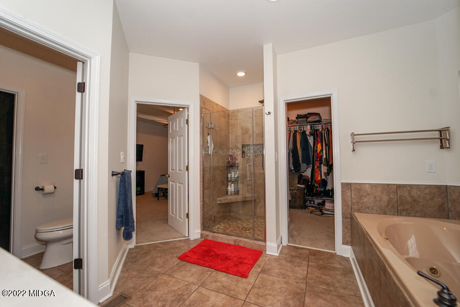 5281 Purple Road Byron, GA 31008 - Photo 23 of 42 a bathroom with a tub a toilet and a shower