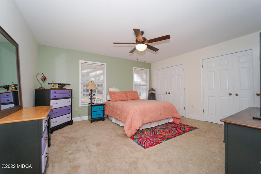 5281 Purple Road Byron, GA 31008 - Photo 27 of 42 a bedroom with a bed and a chandelier