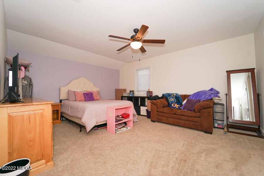 5281 Purple Road Byron, GA 31008 - Photo 32 of 42 a bedroom with a bed and a chandelier