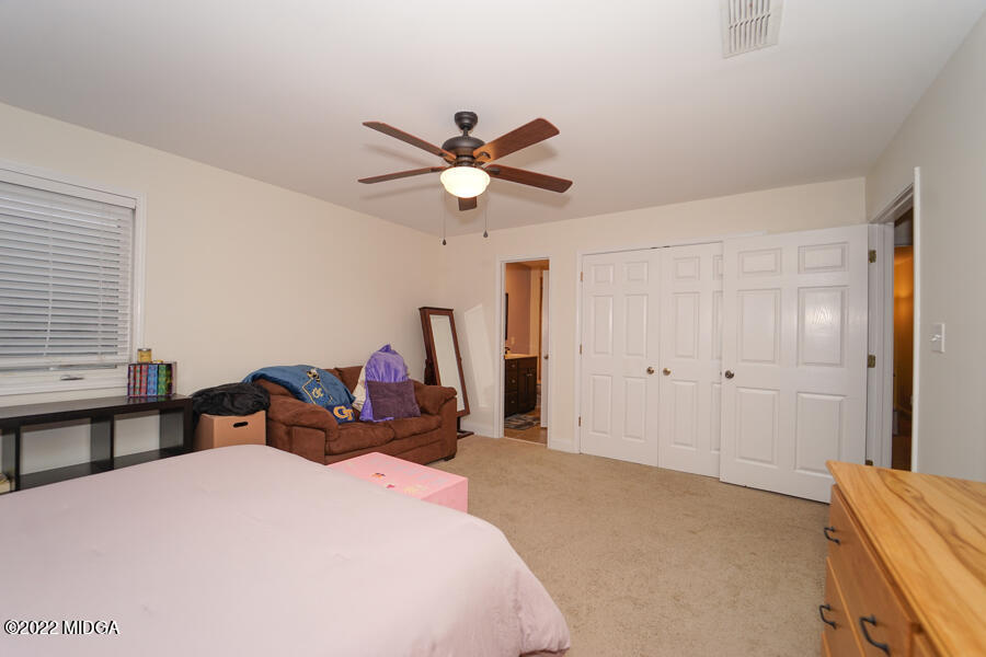 5281 Purple Road Byron, GA 31008 - Photo 33 of 42 a bedroom with a bed and a chandelier
