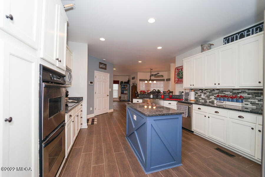 5281 Purple Road Byron, GA 31008 - Photo 10 of 42 a kitchen with cabinets and wooden floor