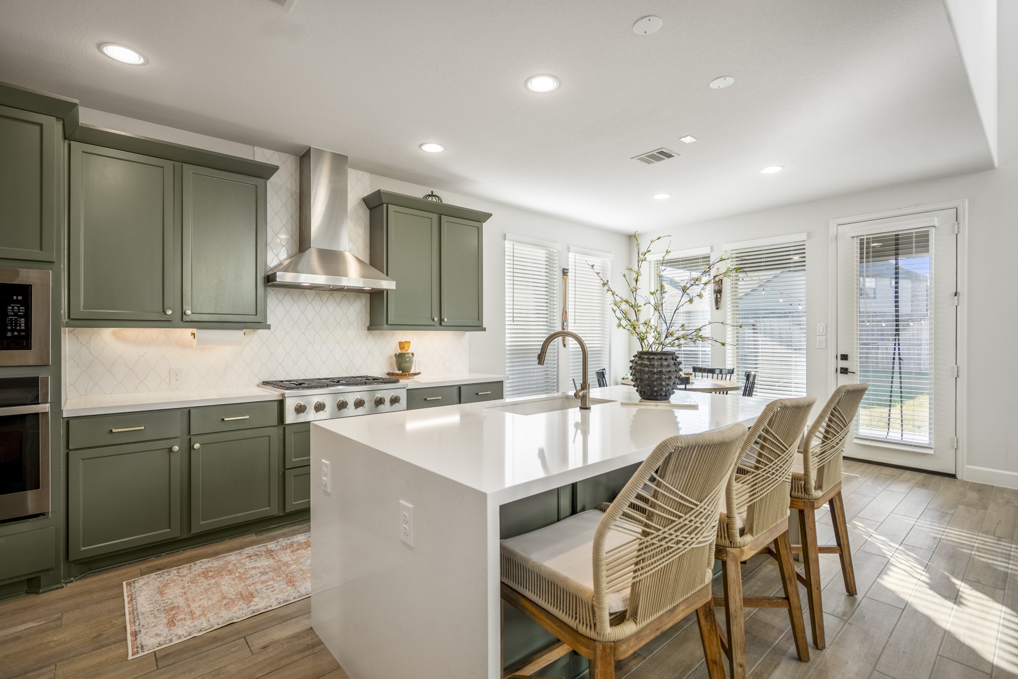 4226 Ana Ridge Lane Fulshear, TX 77441 - Photo 17 of 50 a kitchen with stainless steel appliances granite countertop a sink a stove a refrigerator cabinets and dining table