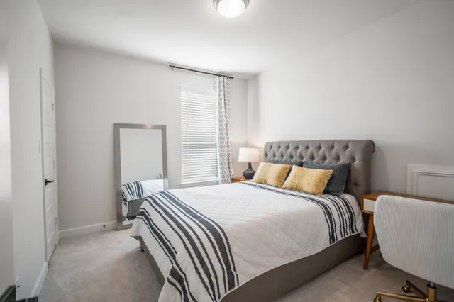 a bedroom with a bed and a lamp