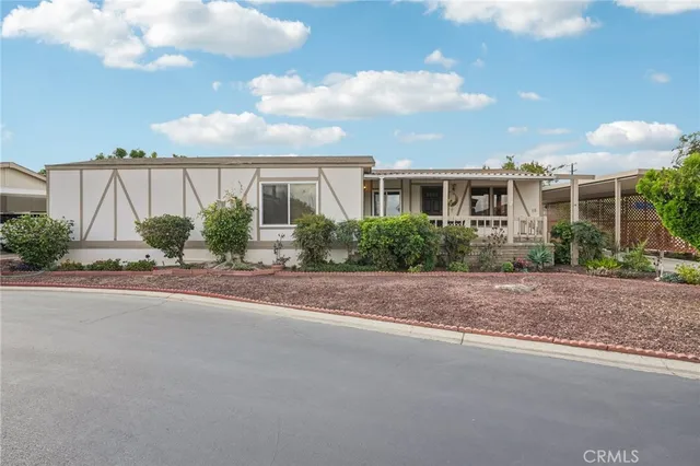 a view of a house with a yard and plants