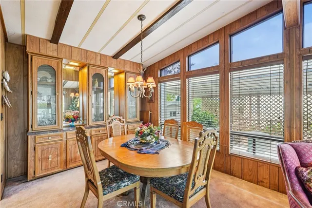 a dining room with furniture a chandelier and wooden floor