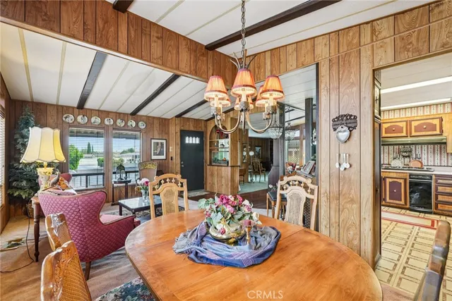 a view of a dining room with furniture a chandelier and wooden floor