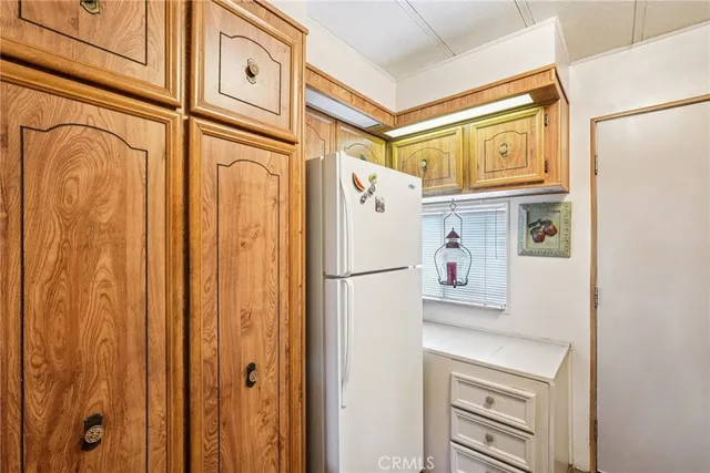 a white refrigerator freezer and a window in a kitchen