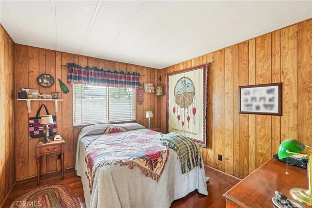 a bedroom with a bed and a painting on the wall