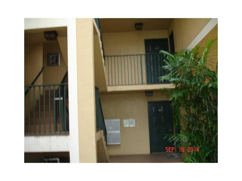 9033 Wiles Road, Unit 1084 Coral Springs, FL 33067 - Photo 6 of 12 a view of entryway with a small yard