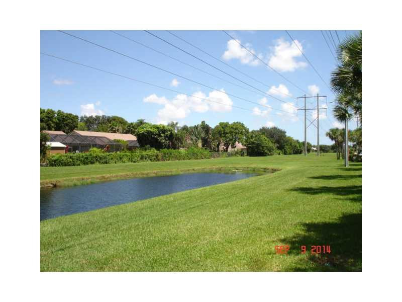 9033 Wiles Road, Unit 1084 Coral Springs, FL 33067 - Photo 7 of 12 a view of a golf course with a lake