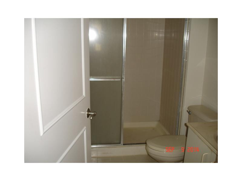 9033 Wiles Road, Unit 1084 Coral Springs, FL 33067 - Photo 8 of 12 a bathroom with a shower