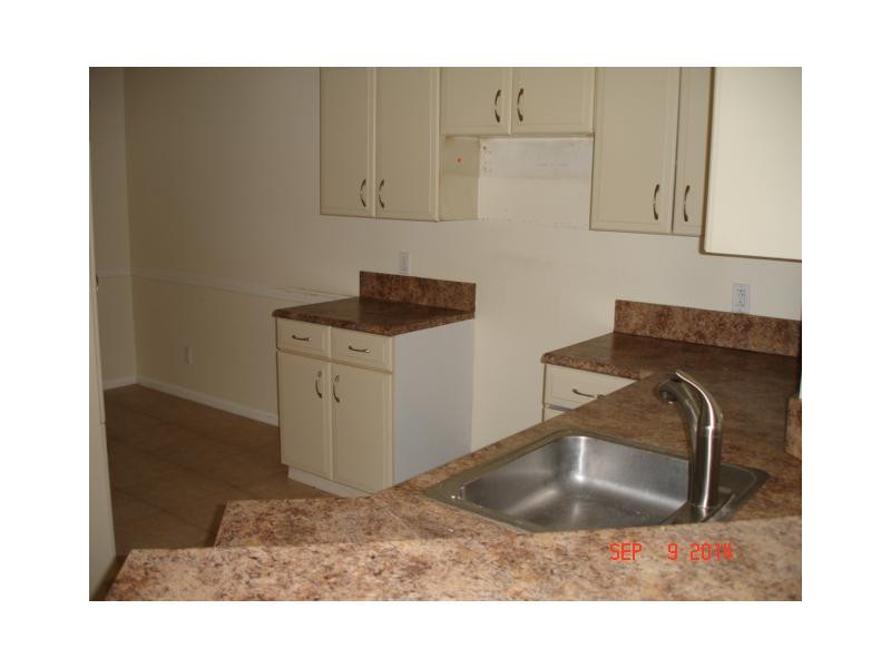 9033 Wiles Road, Unit 1084 Coral Springs, FL 33067 - Photo 9 of 12 a sink and cabinets