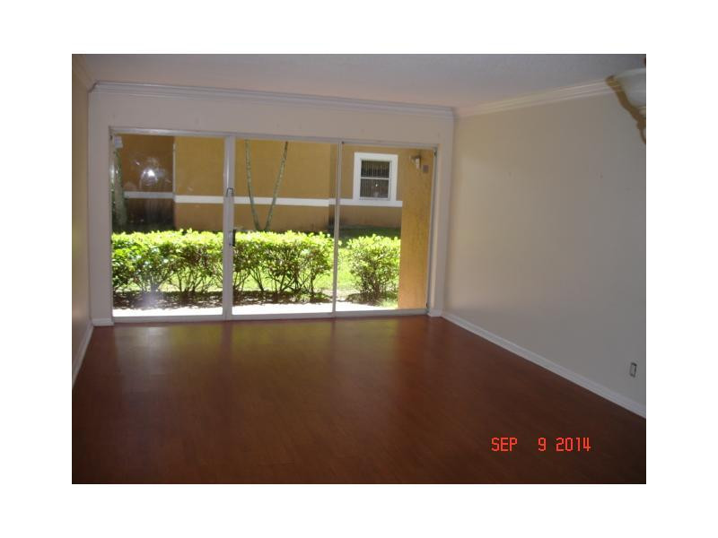 9033 Wiles Road, Unit 1084 Coral Springs, FL 33067 - Photo 10 of 12 a black and white photo of a living room