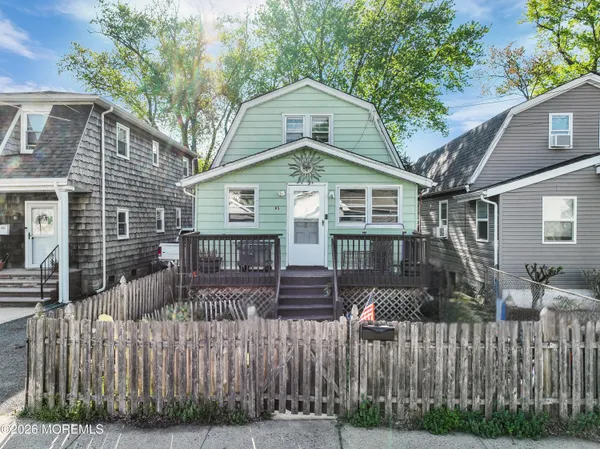 a front view of house with wooden fence
