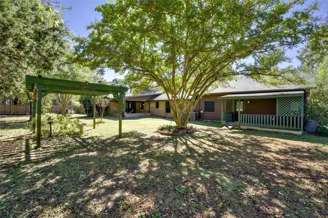 a front view of a house with a tree