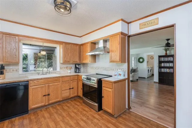 a kitchen with stainless steel appliances granite countertop a stove and a sink