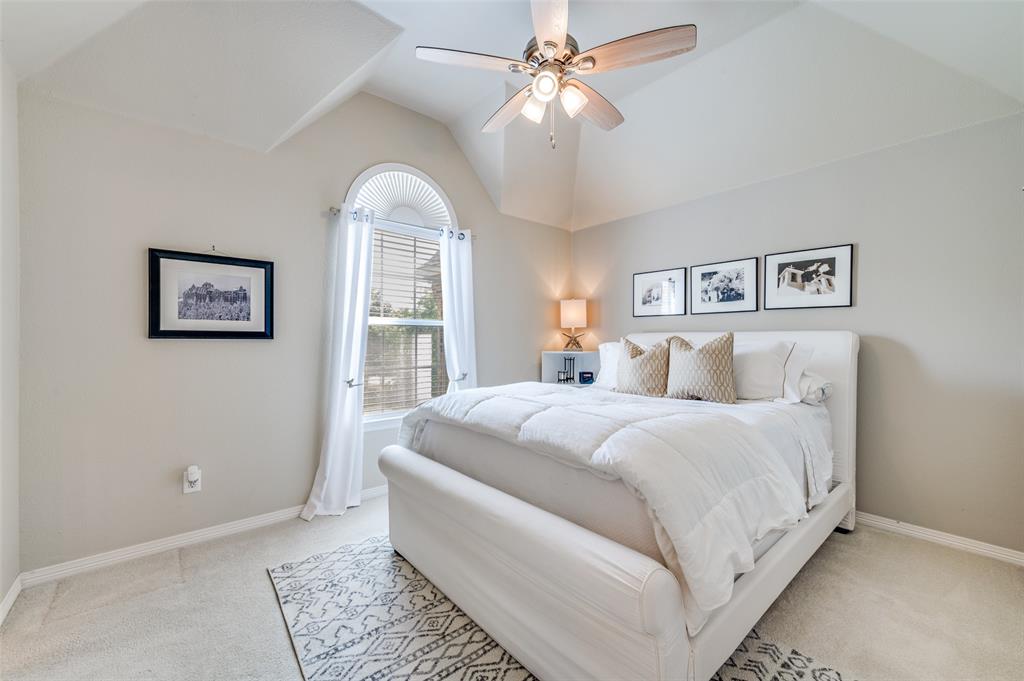 2841 Winding Creek Road Prosper, TX 75078 - Photo 26 of 40 a spacious bedroom with a large bed and a chandelier