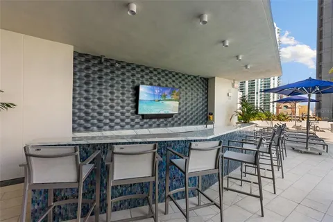 a swimming pool view with outdoor seating