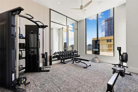 a view of a room with gym equipment and floor to ceiling window
