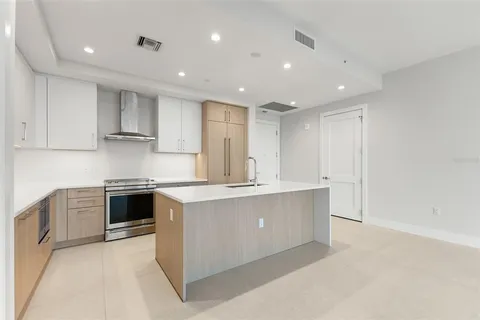 a kitchen with stainless steel appliances granite countertop a stove and a sink