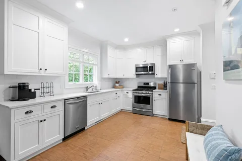 a kitchen with a refrigerator stove and microwave