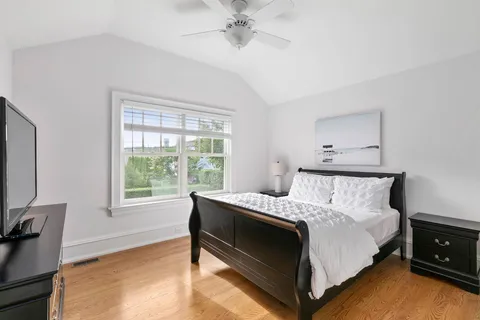 a bed sitting in a bedroom next to a window