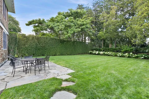 a view of a chairs and table in the garden