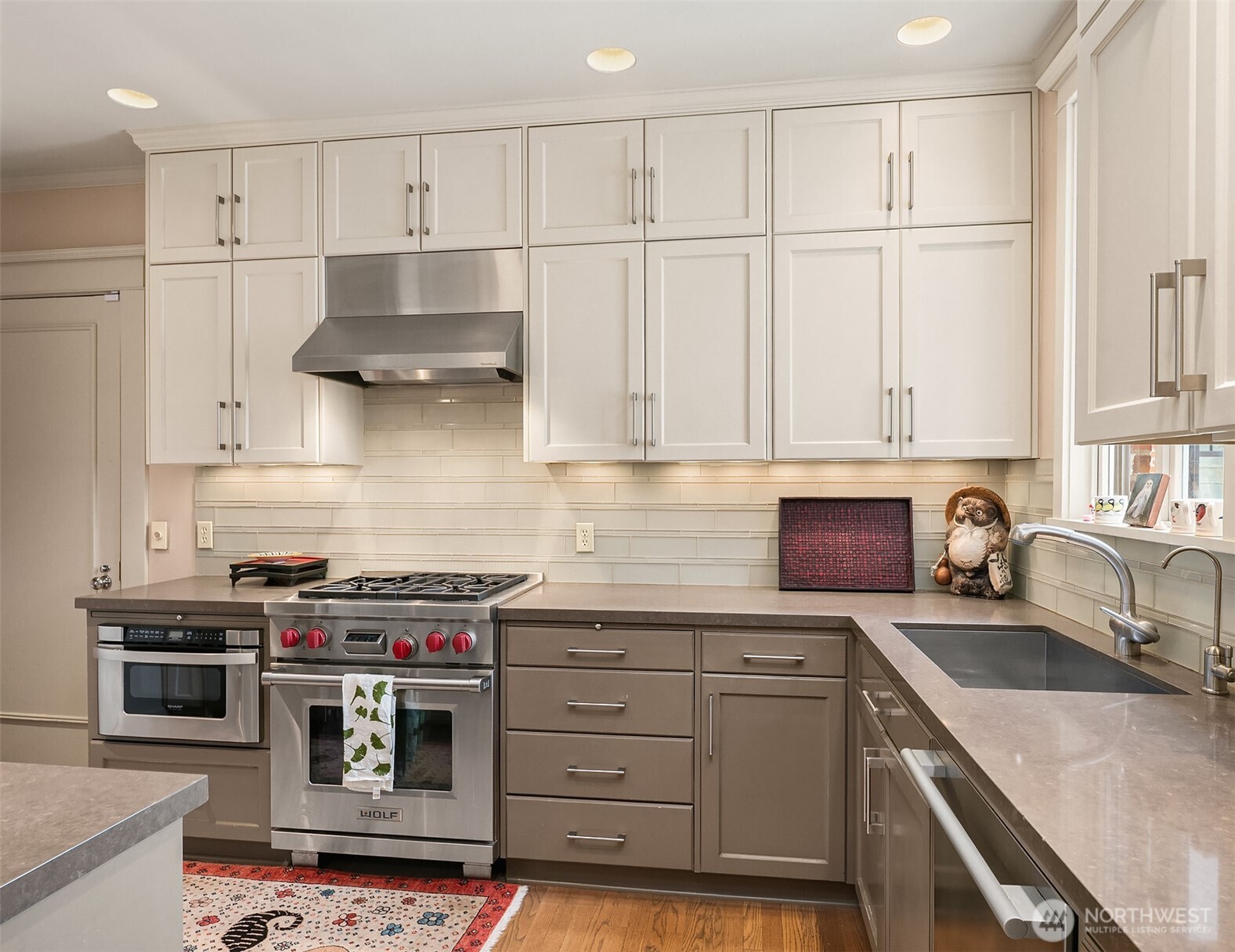 941 11th Avenue East, Unit 3 Seattle, WA 98102 - Photo 13 of 24 a kitchen with stainless steel appliances granite countertop a stove a sink and a refrigerator