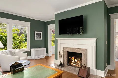 a living room with furniture a flat screen tv and a fireplace