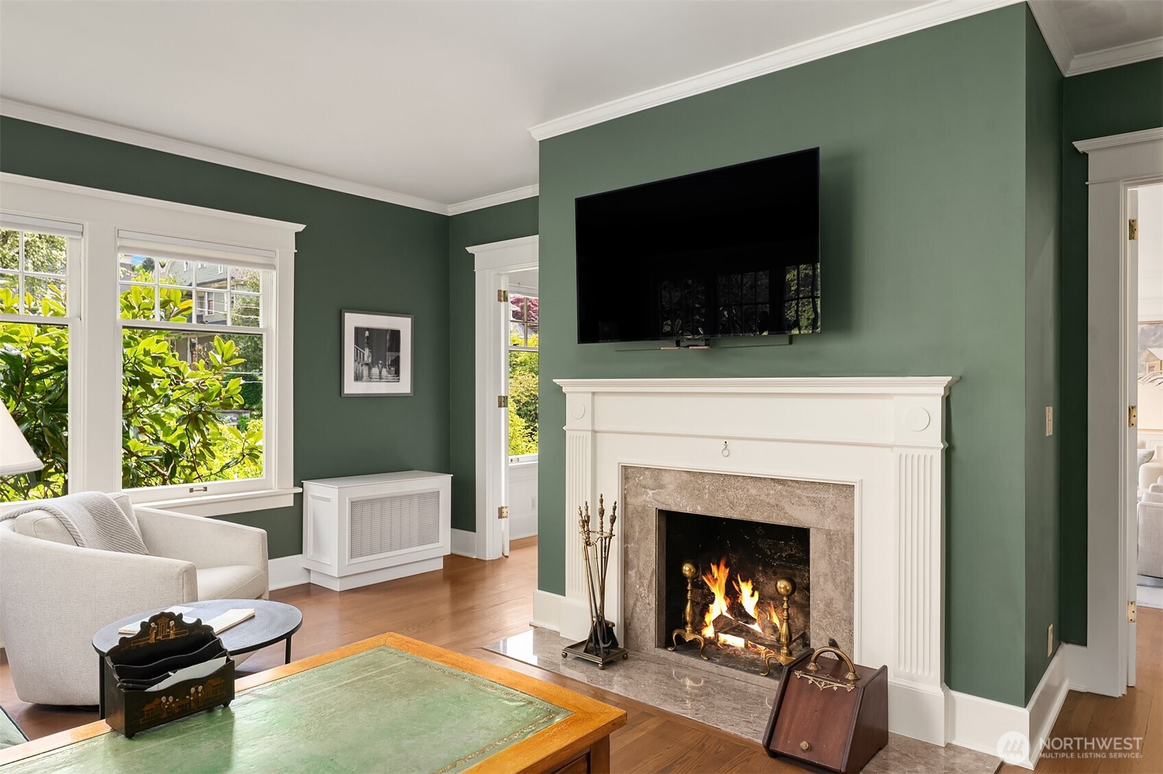 941 11th Avenue East, Unit 3 Seattle, WA 98102 - Photo 6 of 24 a living room with furniture a flat screen tv and a fireplace
