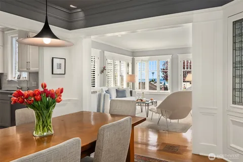a dining room with furniture and wooden floor