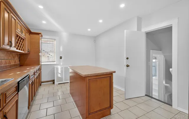 a kitchen that has a sink and a stove in it