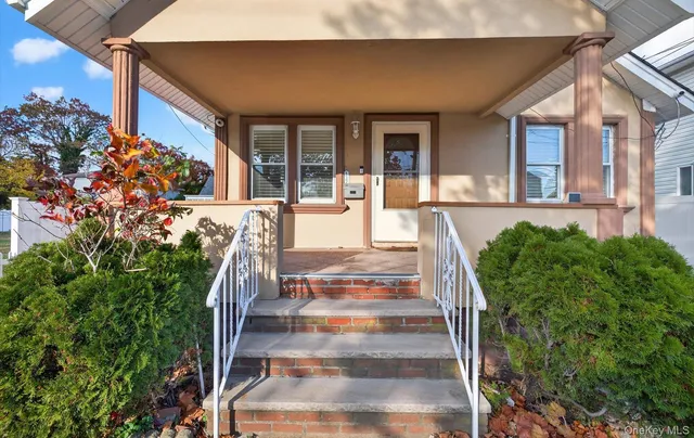 a view of a house with fountain in front of house