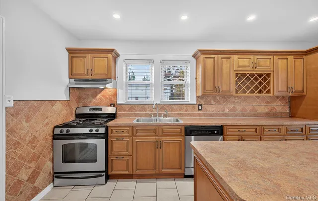 a kitchen with a stove sink and cabinets