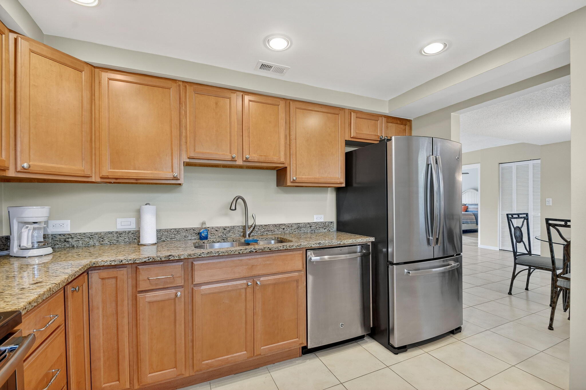 2424 North Federal Highway, Unit 207 Boynton Beach, FL 33435 - Photo 13 of 49 a kitchen with stainless steel appliances granite countertop a refrigerator sink and cabinets