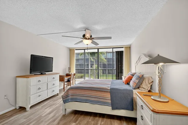 a front view of a house with a yard and lake view