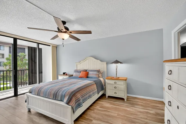 a view of an empty room with window and a ceiling fan