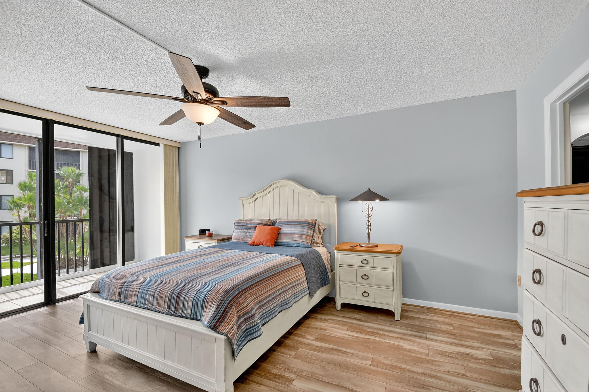 2424 North Federal Highway, Unit 207 Boynton Beach, FL 33435 - Photo 16 of 49 a bedroom with a bed and a chandelier