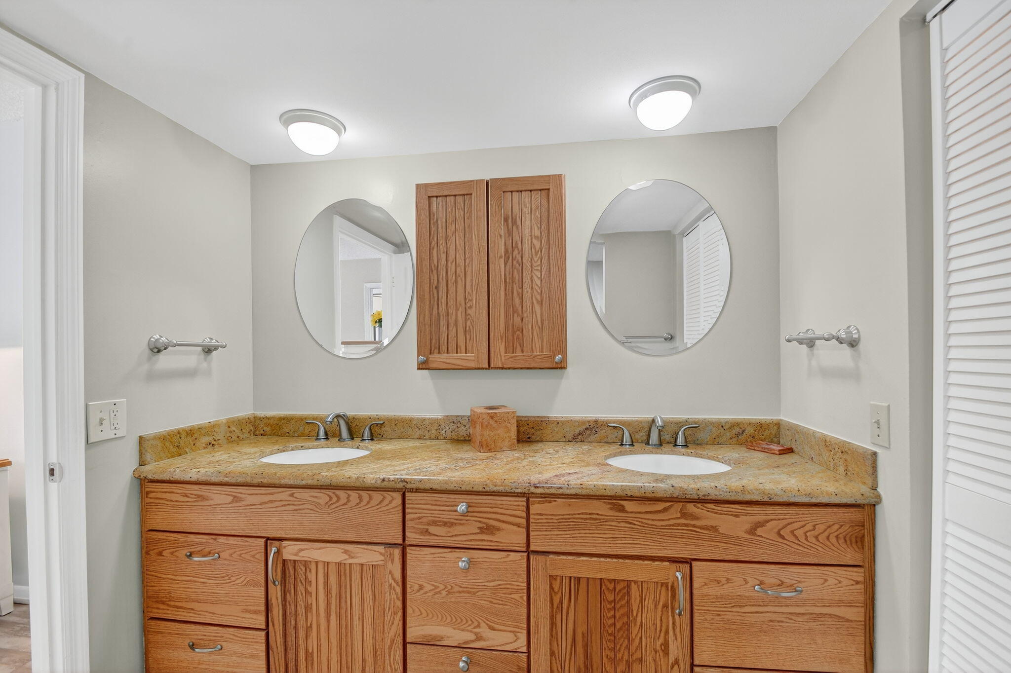 2424 North Federal Highway, Unit 207 Boynton Beach, FL 33435 - Photo 19 of 49 a bathroom with a granite countertop double vanity sink and a mirror