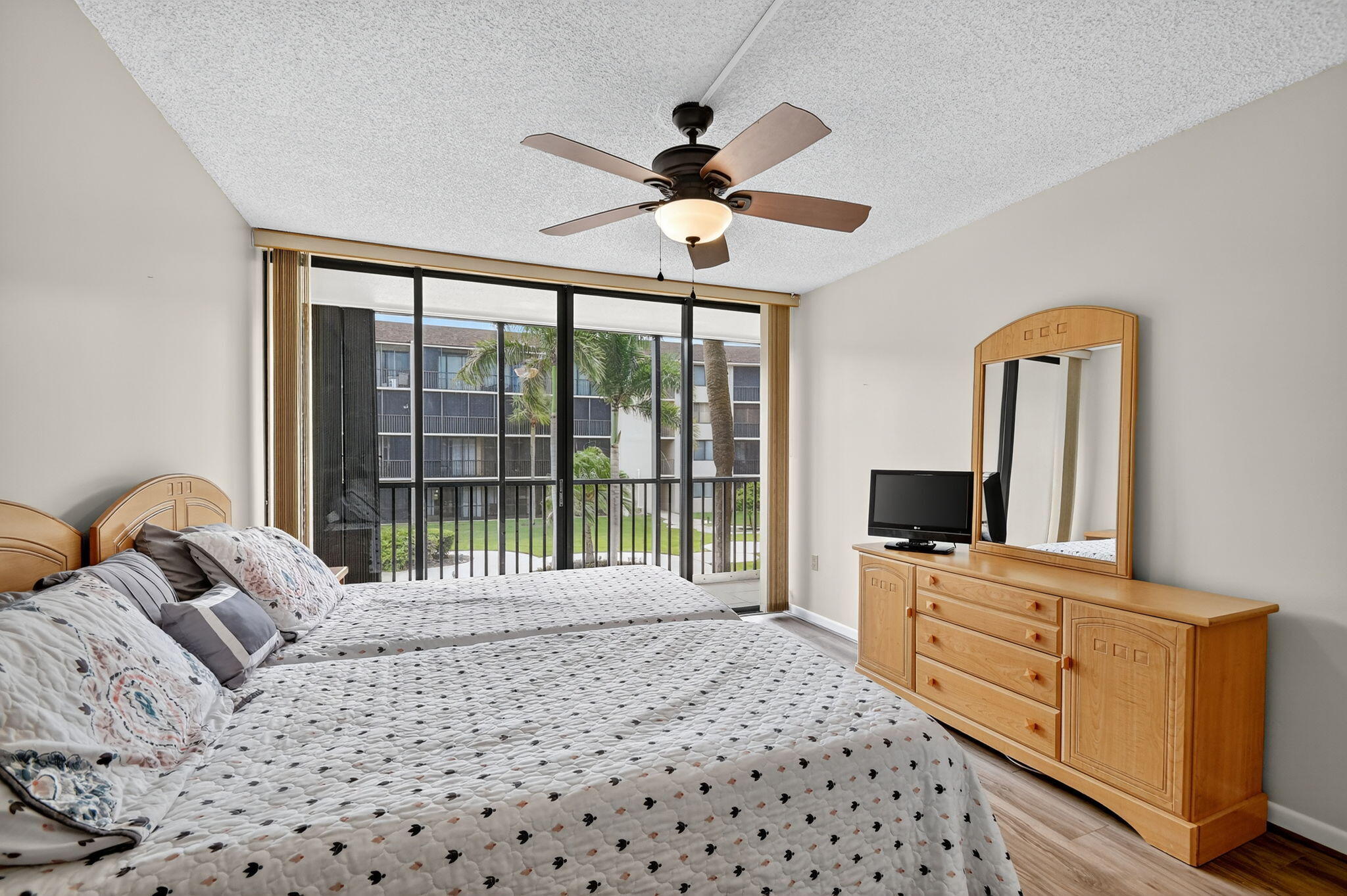 2424 North Federal Highway, Unit 207 Boynton Beach, FL 33435 - Photo 22 of 49 a bedroom with furniture and a flat screen tv