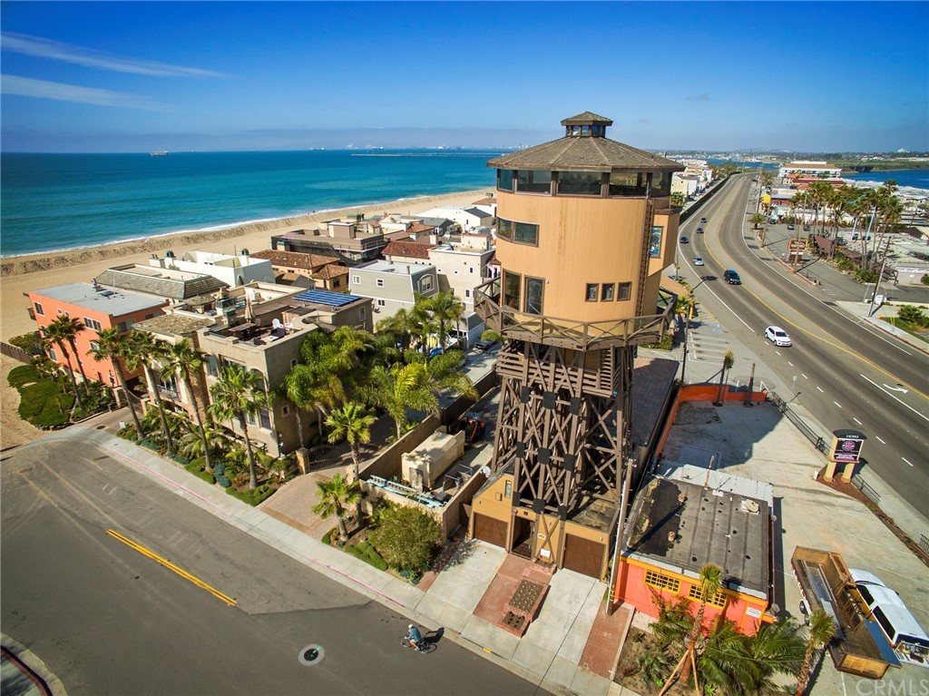 an aerial view of a residential building and an ocean view