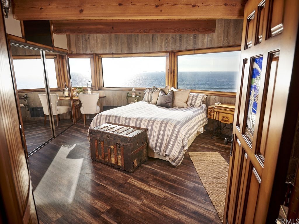 1 Anderson Street Seal Beach, CA 92649 - Photo 15 of 23 a bedroom with a bed wooden floor and window