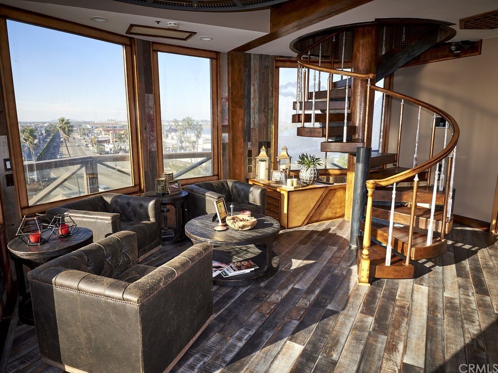 1 Anderson Street Seal Beach, CA 92649 - Photo 9 of 23 a living room with fireplace furniture and a large window